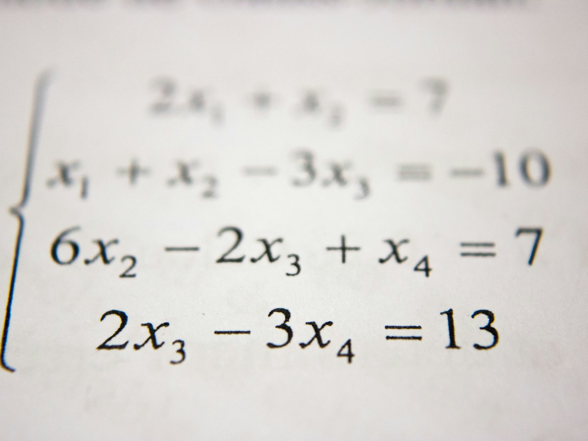 A system of linear equations printed on a sheet of paper